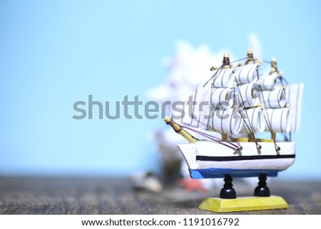 Old wooden ship with sails and masts toy on a stand. Vintage and retro toys
