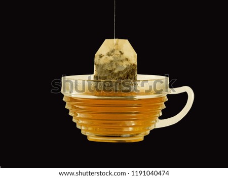 Putting a herbal teabag in a cup of fresh hot water