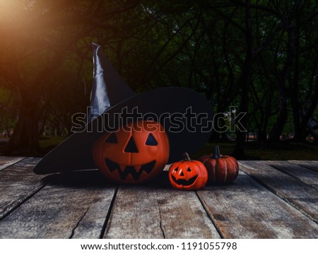 Halloween background. Spooky pumpkin, Witch hat on wooden floor with moon and dark forest. Halloween design with copyspace