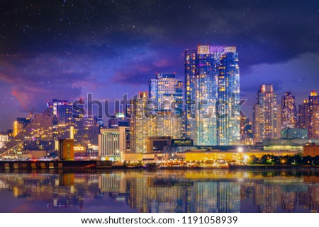Manhattan midtown skyline at twilight over Hudson river with reflections, New York City