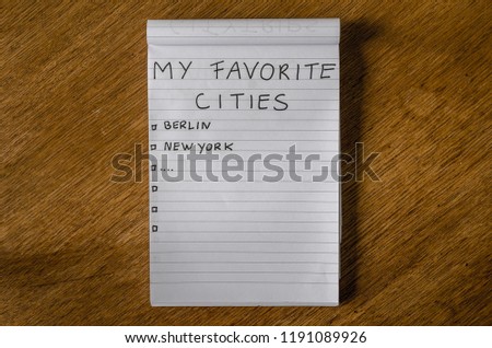 Block note with a list of favorite cities