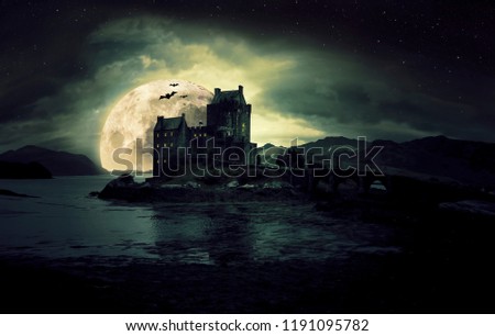 haunted mystic eerie Eilean Donan Castle in Scotland with the sea around it and dark clouds Royalty-Free Stock Photo #1191095782