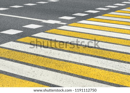 Asphalt road crosswalk with marking lines white and yellow stripes
