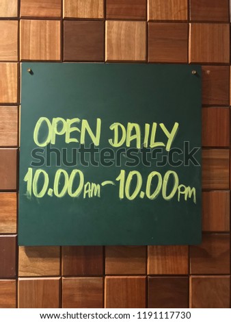 A business hours signboards on the wall