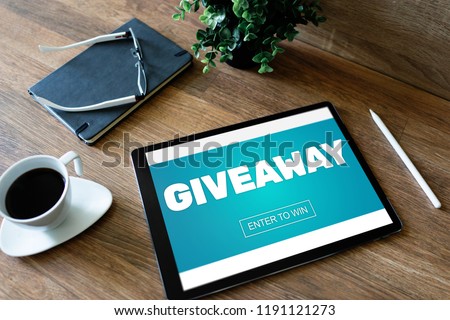 Giveaway, enter to win text on screen. Lottery and prizes. Social media marketing and advertising concept. Royalty-Free Stock Photo #1191121273