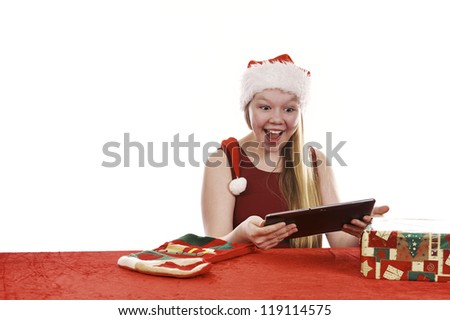 Beautiful young girl in christmas dress retrieving present from traditional christmas stocking on white background
