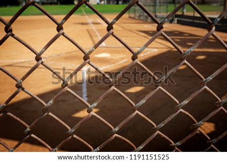 Empty baseball field behind fence                              