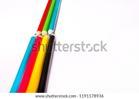Seven colored pencils. The colors red, green, blue, cyan, magenta, yellow and black. Concept of color profiles converting.