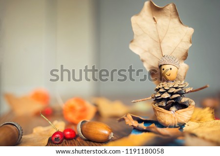 autumn craft with kids. children's cute boat with man made of natural materials. Royalty-Free Stock Photo #1191180058