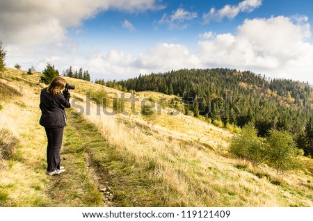 woman taking photo during mountain trip,beauyfull landscape