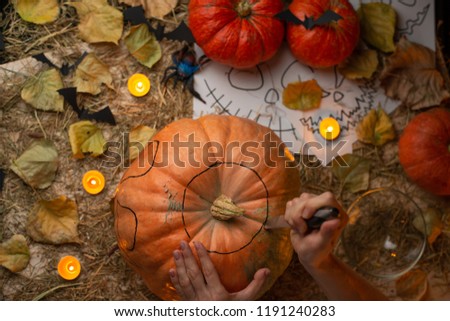 Preparing pumpkins for Halloween, with candles