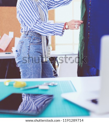Fashion designer working on her designs in the studio