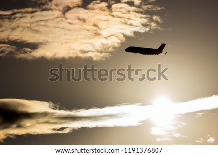 A flying airliner in the evening sky - a contour photograph in the backlight. Contre-jour is a photographic technique in which the camera is pointing directly toward a source of light