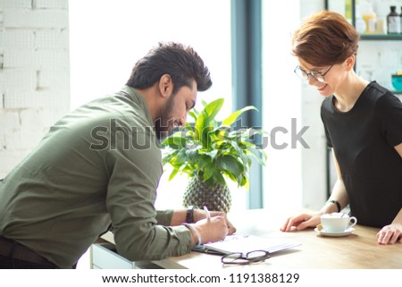business woman and business man talking about deals at meeting in modern office and sign documents or writing notes