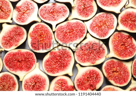 Cut ripe figs as background, top view