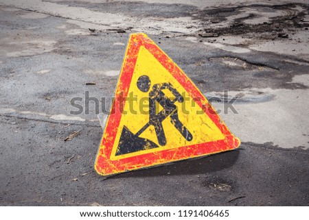 Road works are under way. Silhouette of a working person