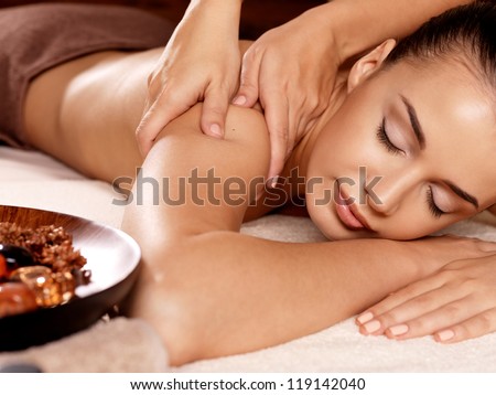 Masseur doing massage on woman body in the spa salon. Beauty treatment concept. Royalty-Free Stock Photo #119142040