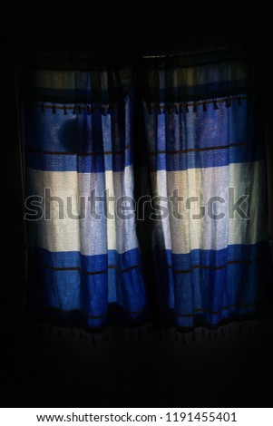 Blue curtains with light coming into the window