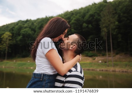 Beautiful couple walking in the park near the lake