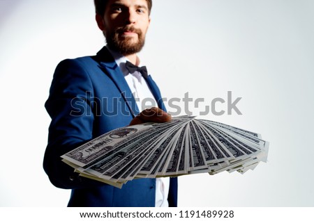 paper money banknotes man in suit in the background                             