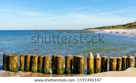 Wooden breakwater and Baltic Sea in sunny day, Poland