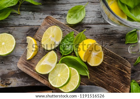 Fresh lime and lemons, ready to serve in drink, food photography, rustic, wood board and table