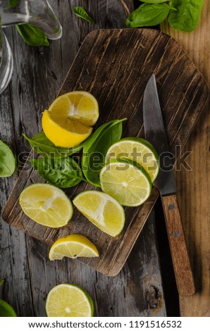 Fresh lime and lemons, ready to serve in drink, food photography, rustic, wood board and table