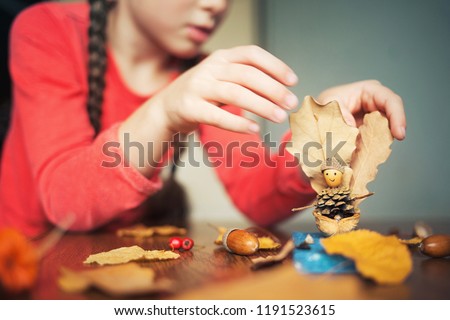 autumn craft with kids. children's cute boat with man made of natural materials. process of creating. Royalty-Free Stock Photo #1191523615