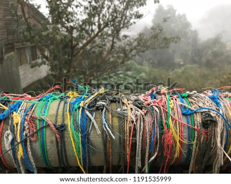 Multicolor of small rope on the wooden bar in the small village. 