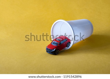 the car leaving from a plastic glass toy, the concept of sale of the car