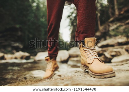 Close up of persons comfortable boots for activities in the forest Royalty-Free Stock Photo #1191544498