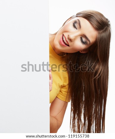 Teenager girl hold white blank paper. Young smiling woman show blank card. Girl with long hair portrait isolated on white background.