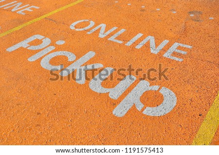 Online pickup sign painted in parking area