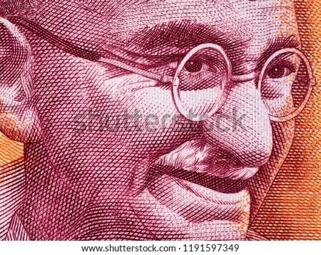 Mahatma Gandhi face portrait on India 200 rupee (2017) banknote close up macro, leader of the Indian independence movement, father of nation Royalty-Free Stock Photo #1191597349