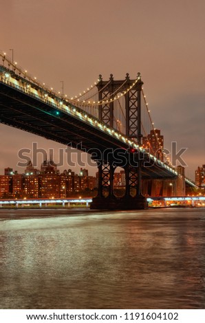 Manhattan Bridge over the East River at sunset. Cityscape of New York