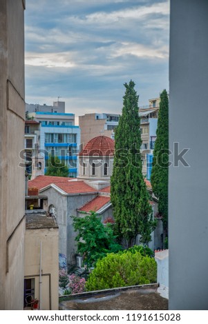 Aghias Dimitrios Greek Orthodox Church in Psiri Athens surrounded by buildings under a cloudy sky