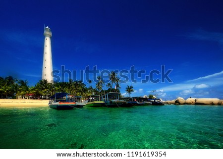 the beautiful island of Lengkuas in Belitung with blue sky and white beach, nice place for holiday  Royalty-Free Stock Photo #1191619354