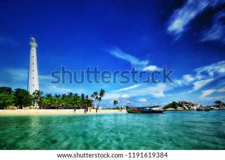 the beautiful island of Lengkuas in Belitung with blue sky and white beach, nice place for holiday  Royalty-Free Stock Photo #1191619384