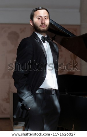 Orchestra musician with a bow in a tuxedo Limited depth of field