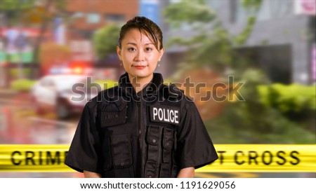 Asian American Woman Police Officer Smiles at Camera