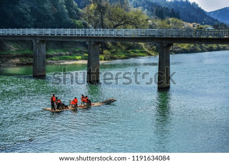 Rivers, bridges, people sitting on bamboo rafts.
