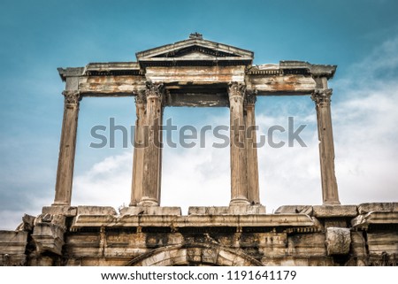 Arch of Hadrian or Hadrian's Gate, Athens, Greece. Detail, top part on the sky background. It is one of the main landmarks in Athens. Vintage view of an ancient Greek monument in Athens center.