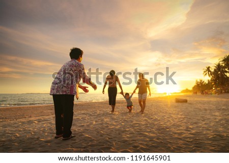 Grandmother and her family play togather on the beach, Phuket beach, Thailand
