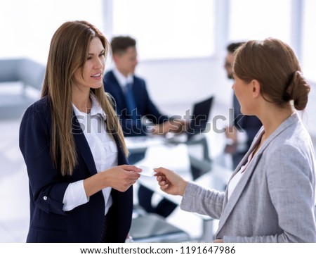 successful business woman gives her business card
