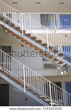 External white fire escape staircase, external emergency exit at hotel building