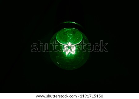 vintage green lighting bulb on the black background