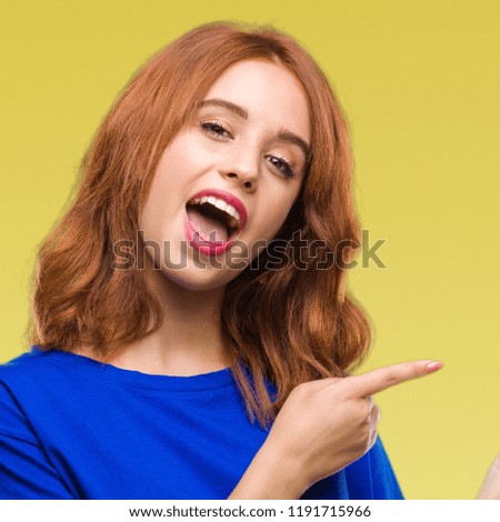 Young beautiful woman over isolated background amazed and smiling to the camera while presenting with hand and pointing with finger.
