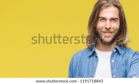 Young handsome man with long hair over isolated background smiling friendly offering handshake as greeting and welcoming. Successful business.