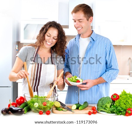 Cooking.Happy Couple Cooking Together - Man and Woman in their Kitchen at home Preparing Vegetable Salad.Diet.Dieting. Healthy Food Royalty-Free Stock Photo #119173096