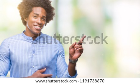 Afro american man over isolated background with a big smile on face, pointing with hand and finger to the side looking at the camera.